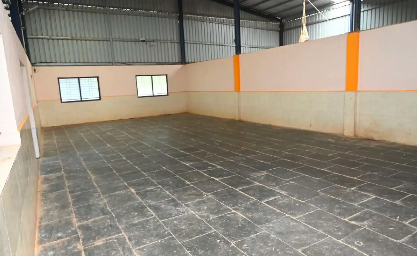 Clean covered storage bay with stone flooring used for holding graded chilli lots